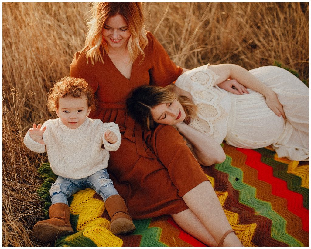 family laying on blanket