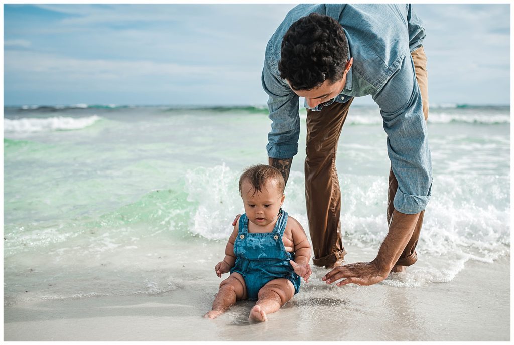father and baby at the beach