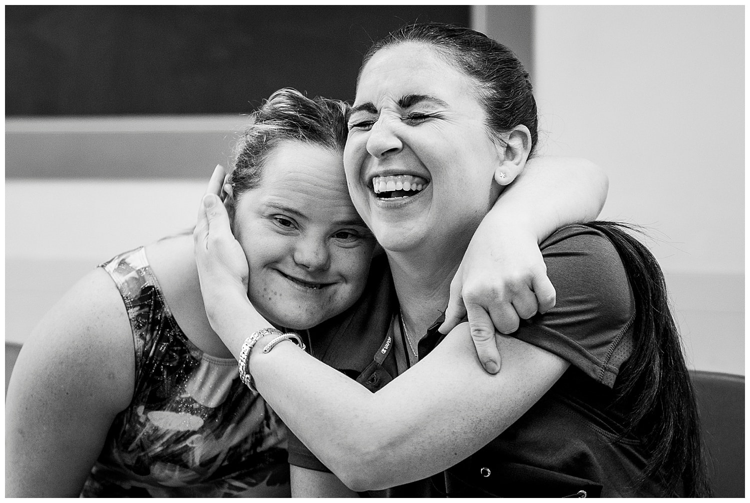 two people hugging at a special olympics event
