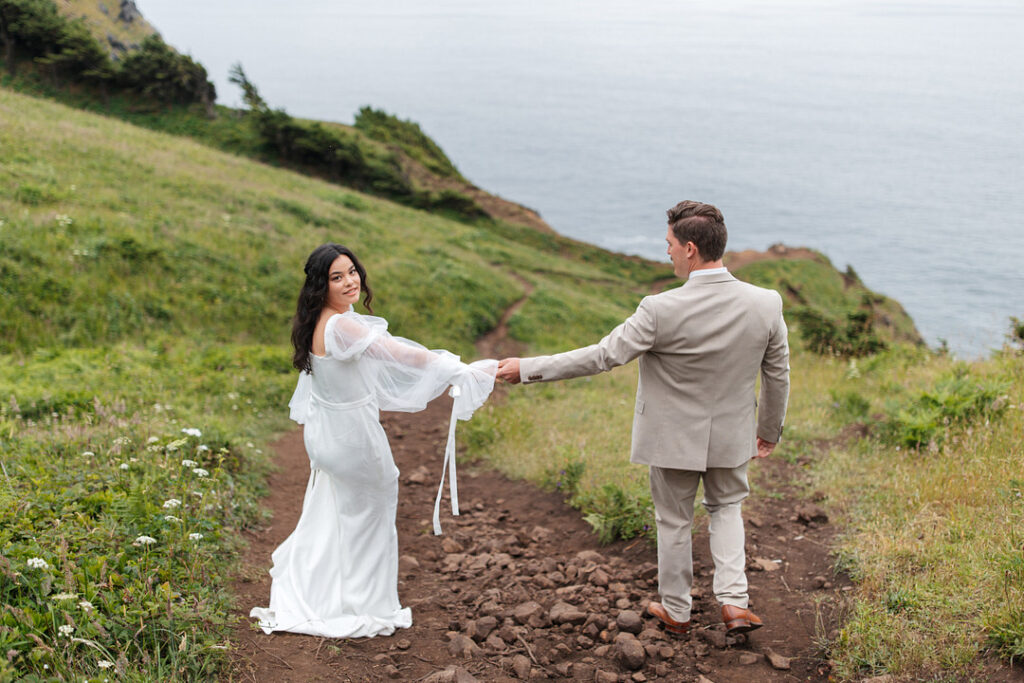 couple walking down costal hill