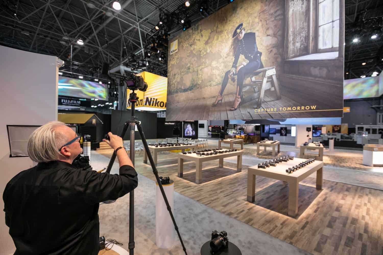 A commercial event photographer sets up to photograph the decor for a convention
