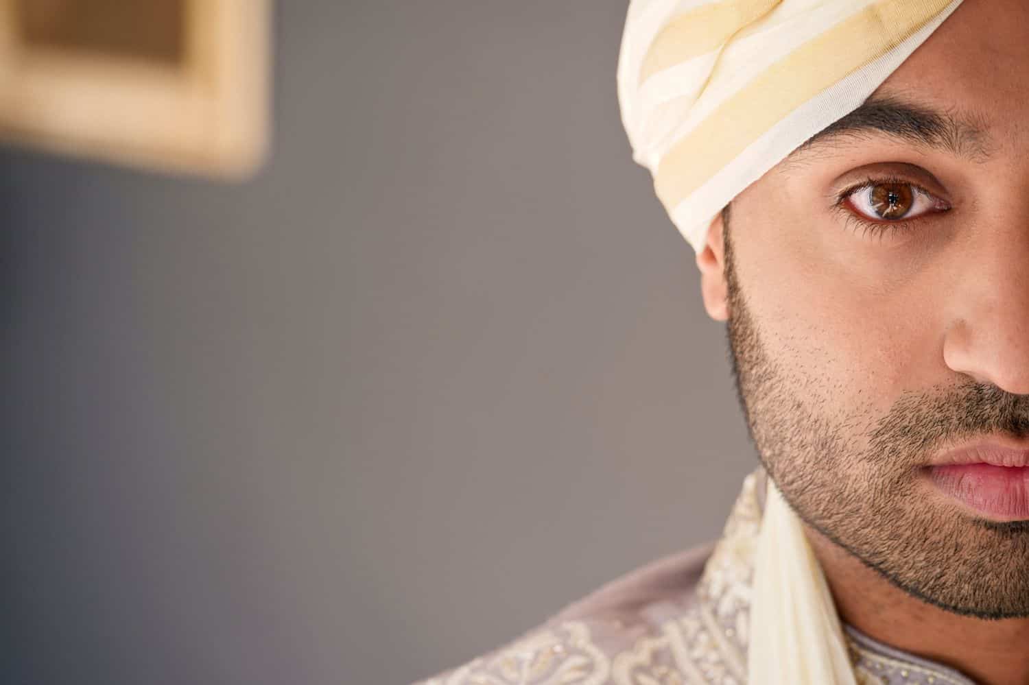 A half portrait of the groom with negative space