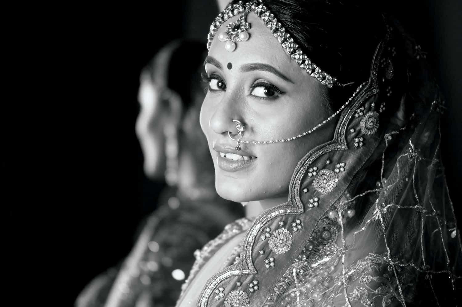 A black and white portrait of the bride