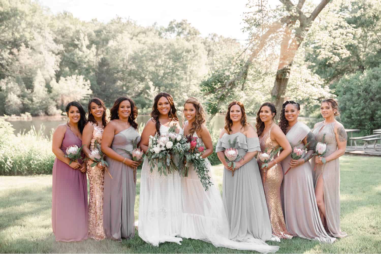 A group photo of two brides and their wedding party