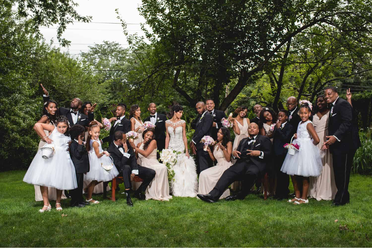 A fun outdoor family wedding photo with a large group