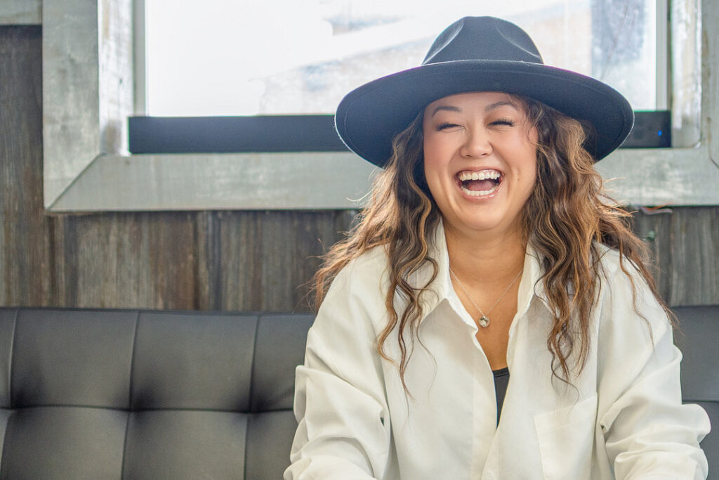woman laughing with grey hat