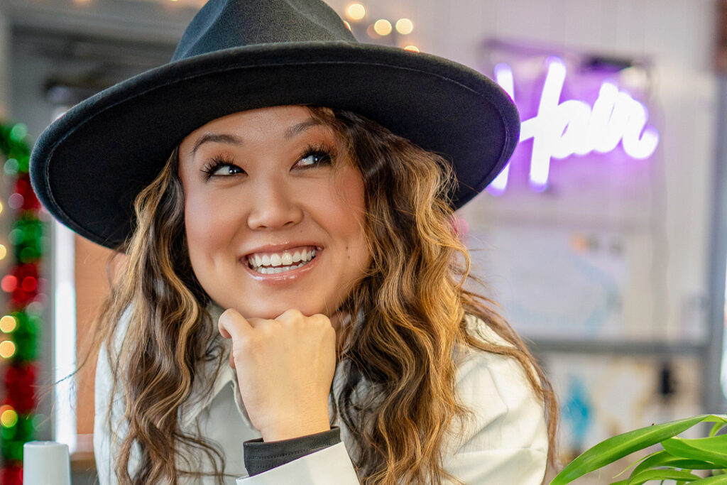 woman smiling with grey hat
