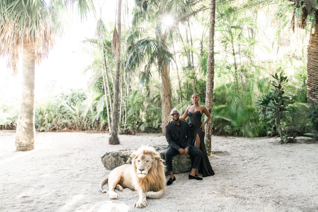 couple posing with lion