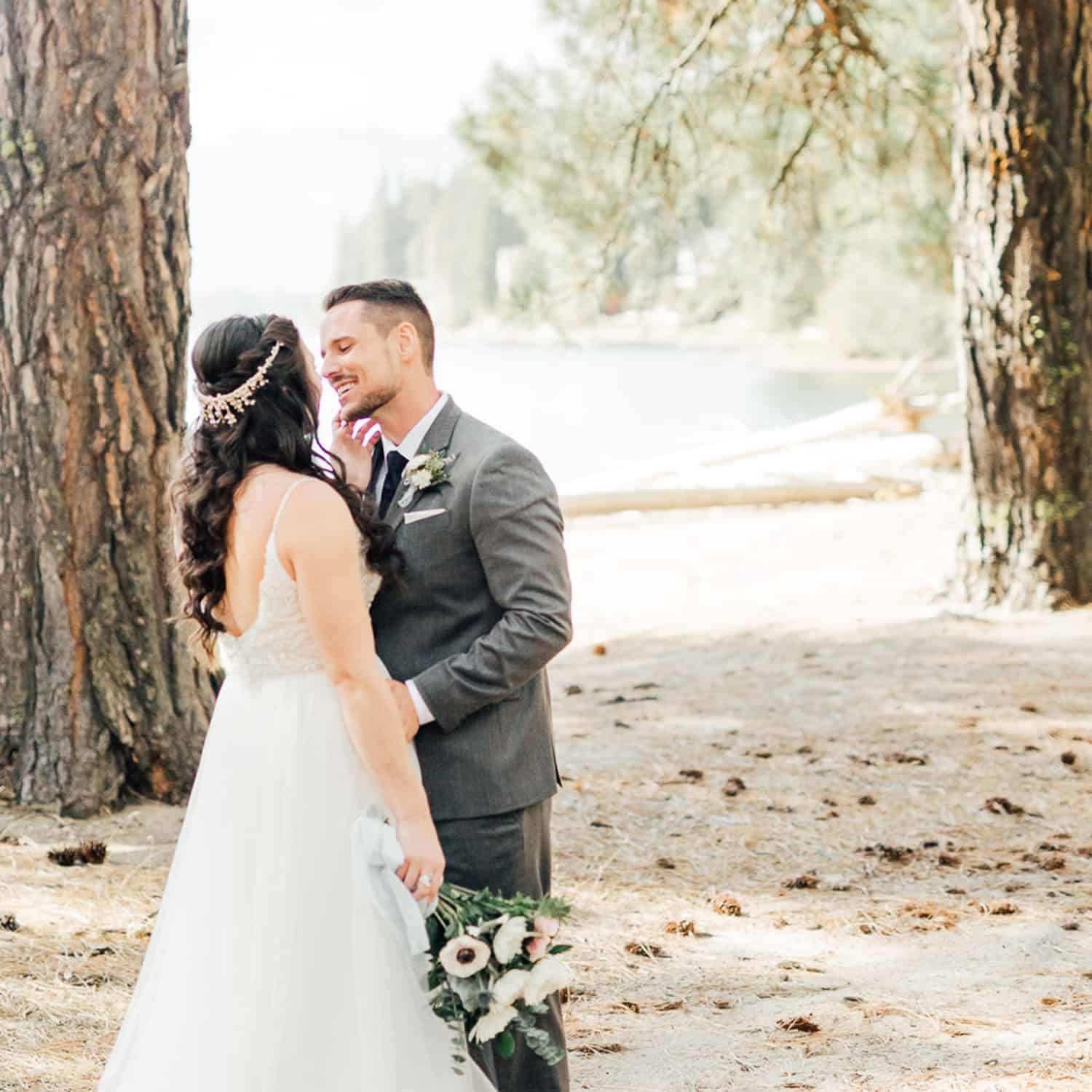 Shelby Schmidt's portrait of a bride and groom gazing into one another's eyes in a lakeside forest