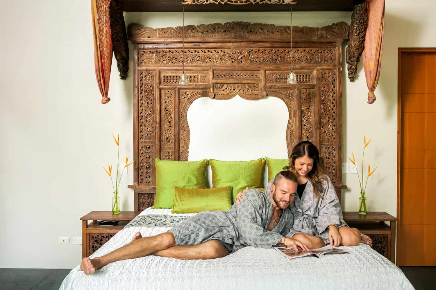 A couple reading a magazine together in bed