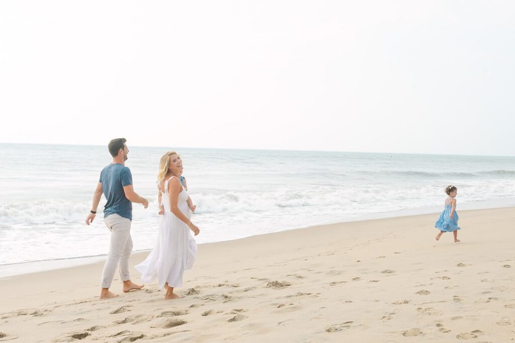 family running on beach