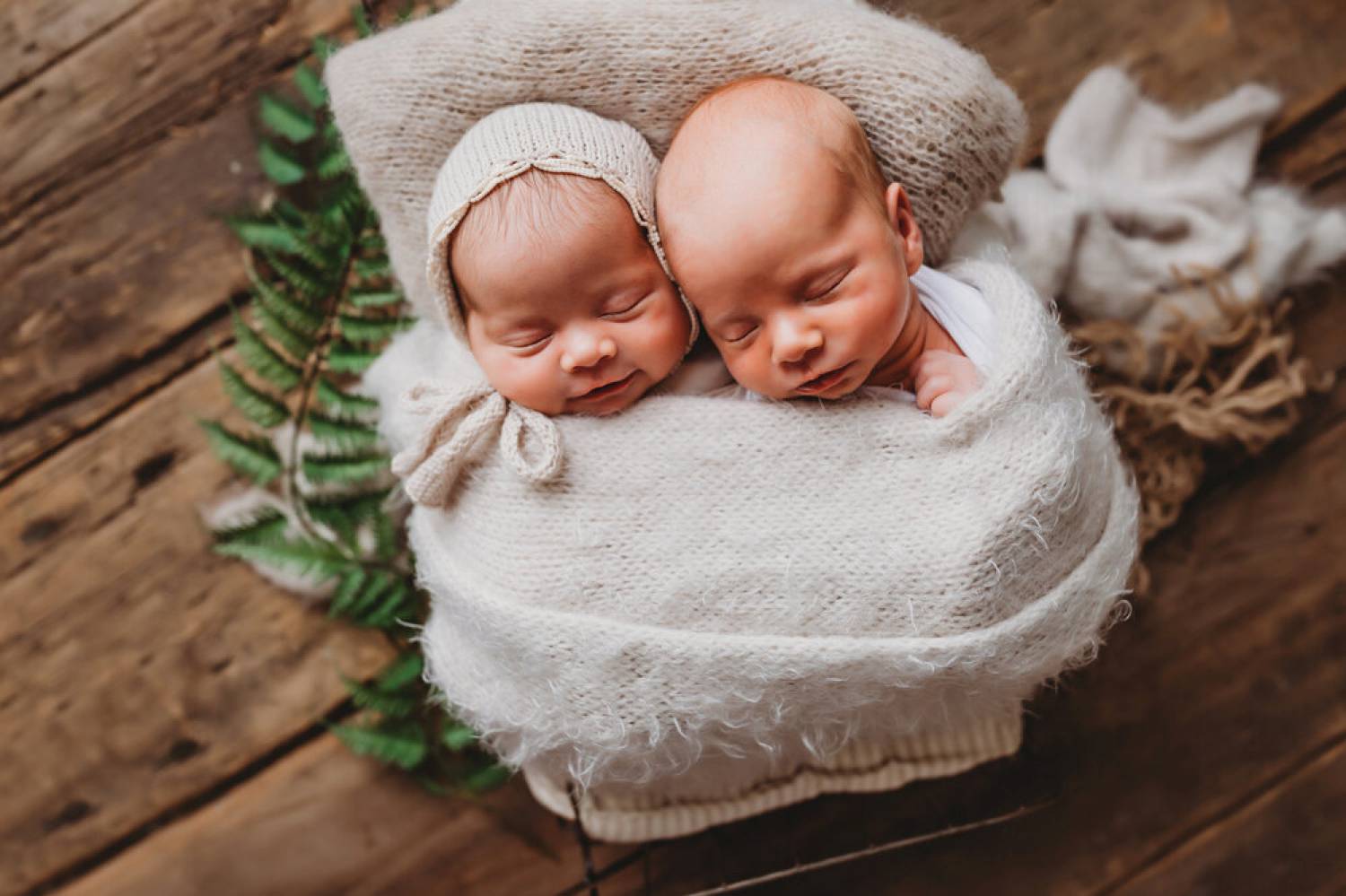 Photo: Brandi RIchardson's portrait of infant twins shows them bundled in soft cloth atop a barnwood backdrop.