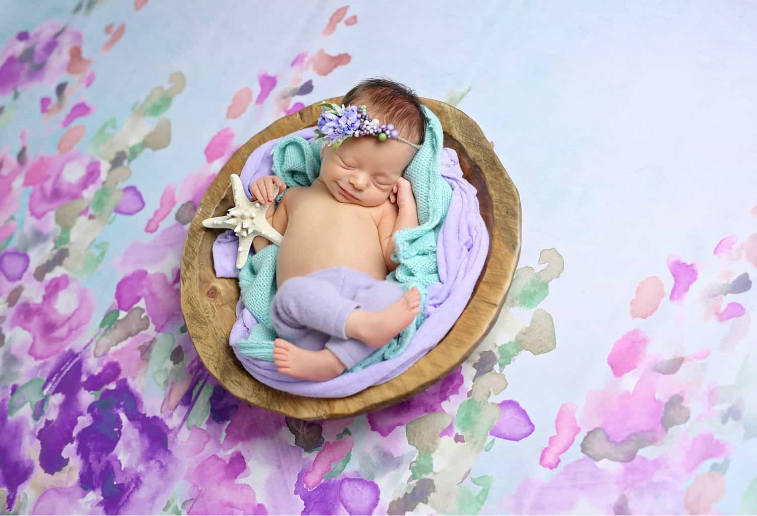 How To Attract New Clients In 3 Bold Business Moves: Baby on watercolor backdrop by Cassie Clayshulte