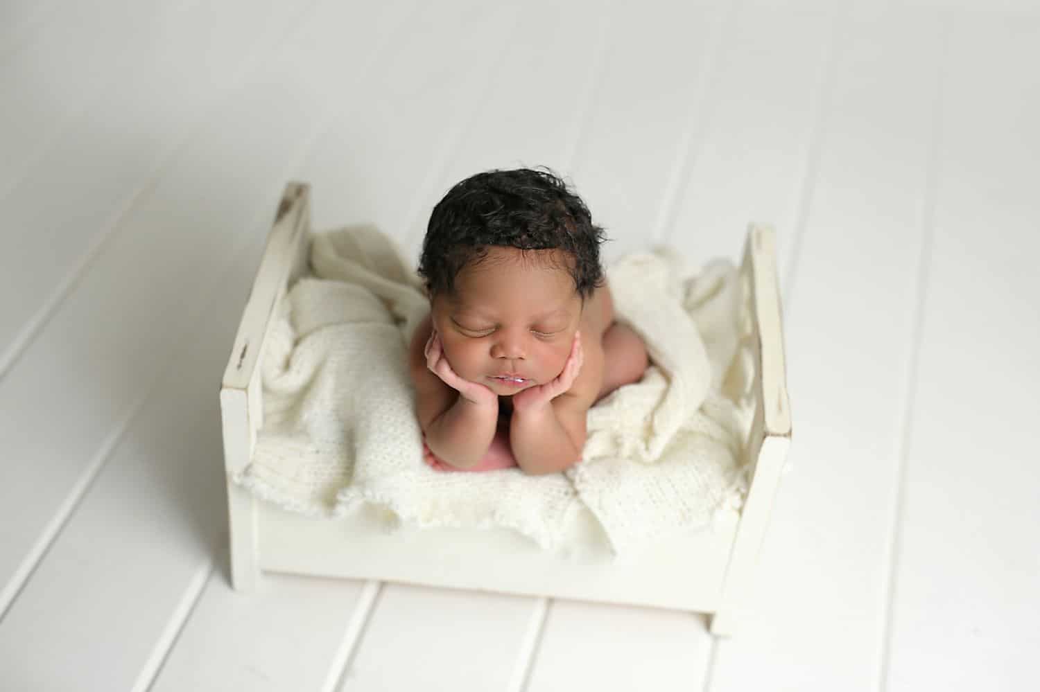 How To Attract New Clients In 3 Bold Business Moves: Baby on a tiny bed by Cassie Clayshulte