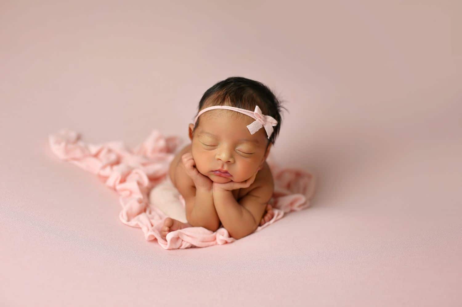 How To Attract New Clients In 3 Bold Business Moves: Newborn baby girl on pink backdrop by Cassie Clayshulte