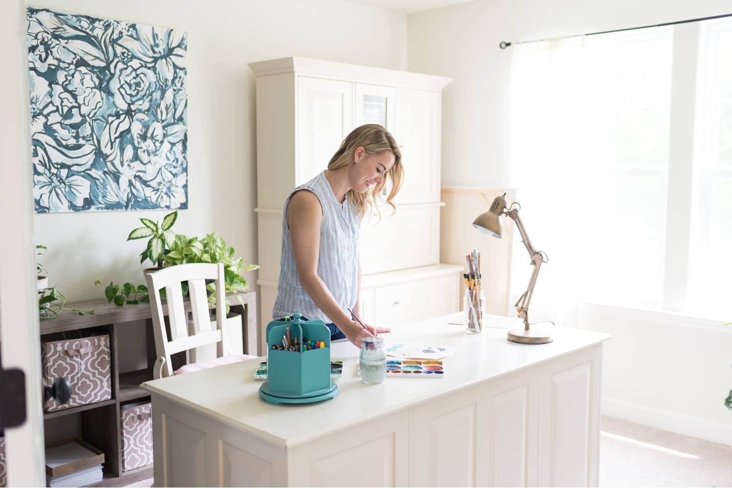 By Mandy Liz: An entrepreneur arranges her desk for a meeting in anticipation of a client feedback call.