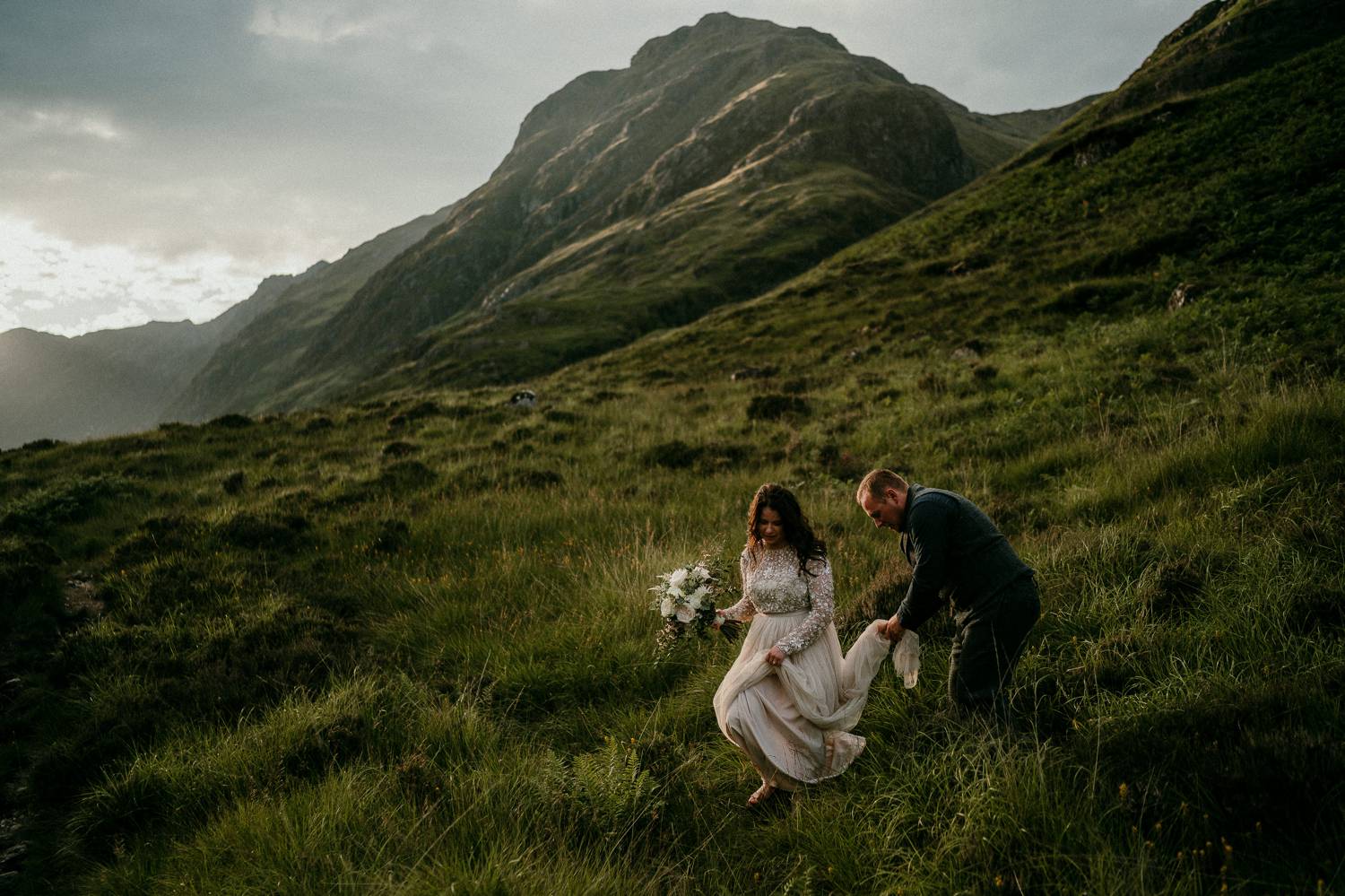 A bride walks delicately down a grassy Irish hill while her groom thoughtfully carries her train. Selling photography prints is simple when you prioritize quality over speed or cost. This image was made by Rob Dight.