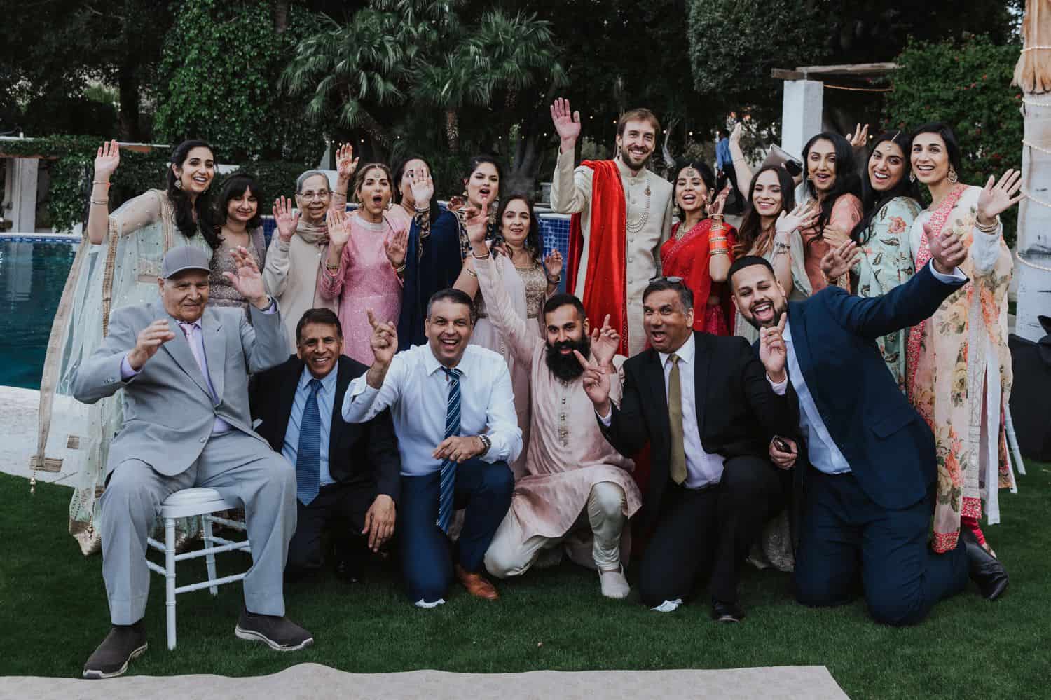 Large Indian family portrait at a wedding outside