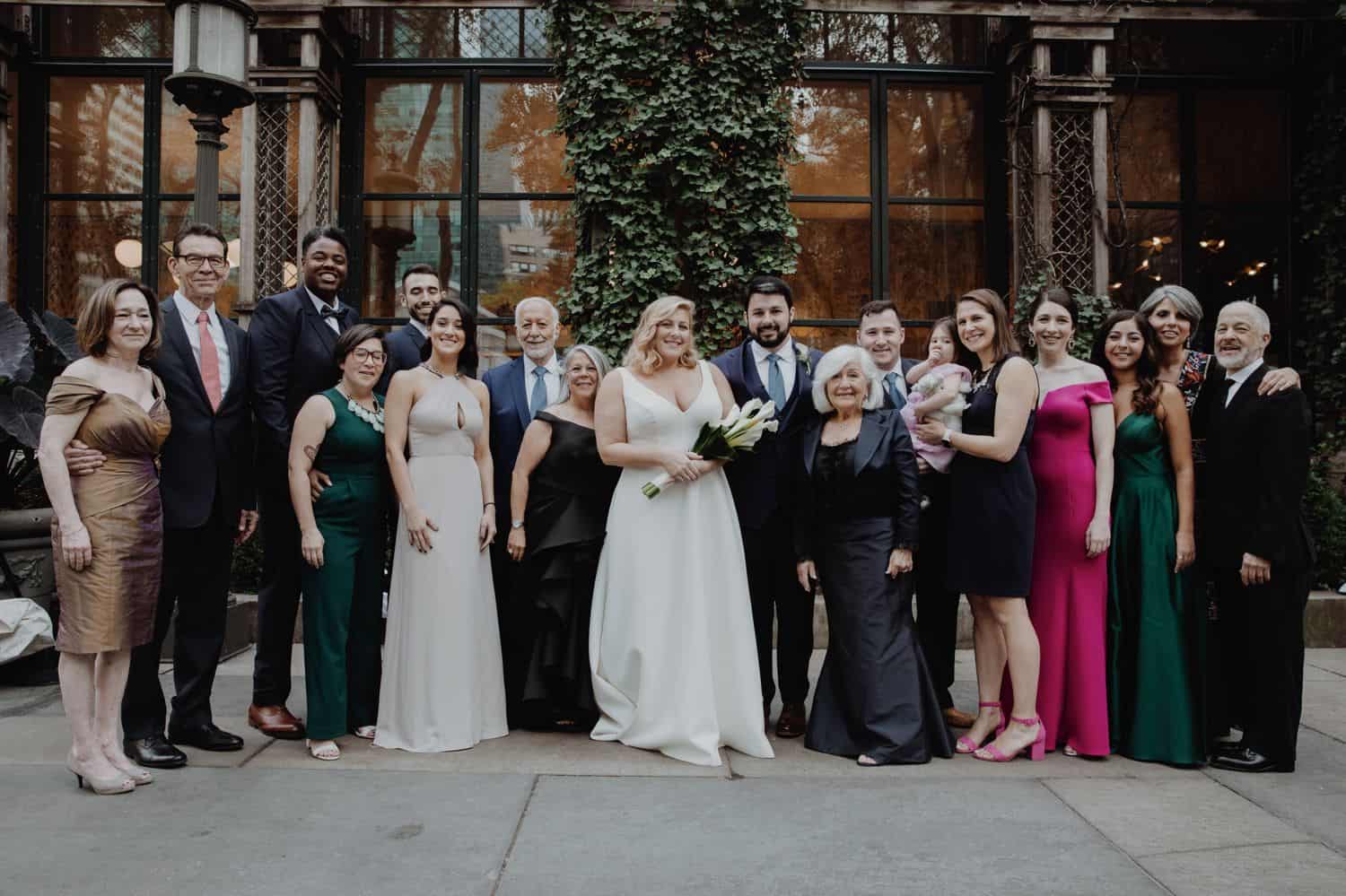 Large family portrait at a wedding in a courtyard