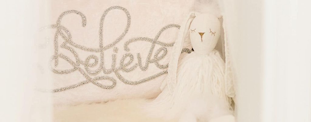 header believe pillow and stuffed bunny