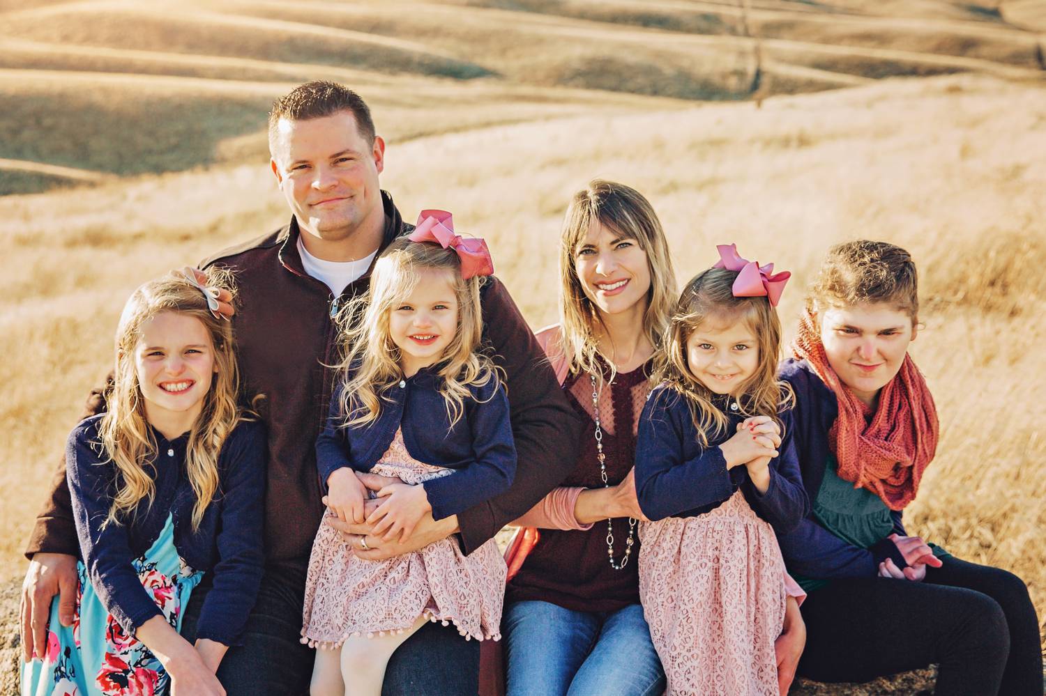 A family with special needs children poses for a portrait by Danielle Torres