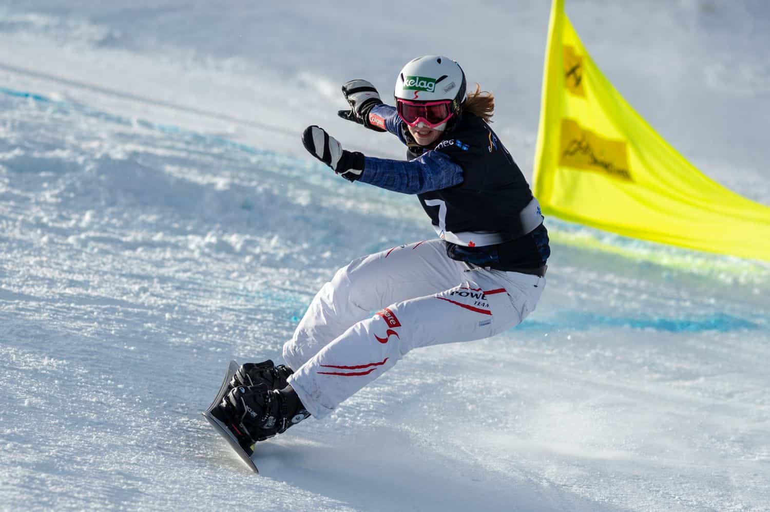 A woman snowboarding down a hill