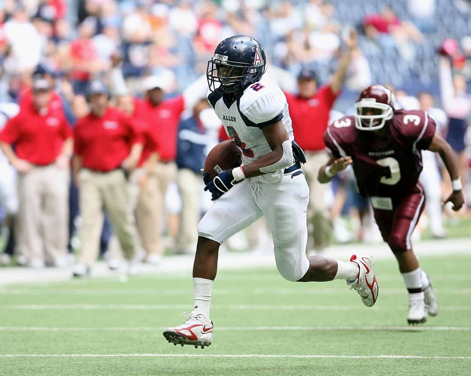 A football player running on the field with a ball