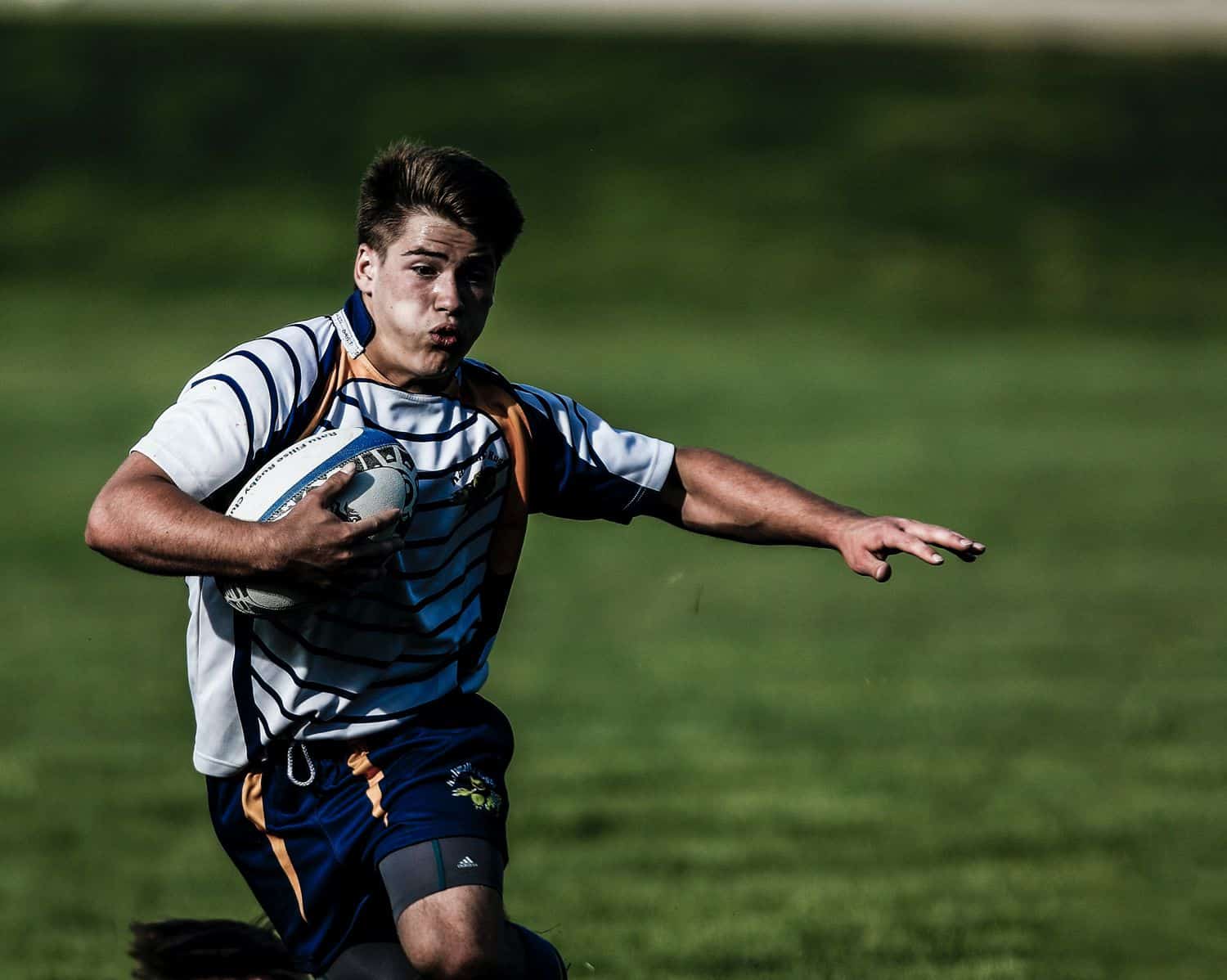 A rugby player running with ball