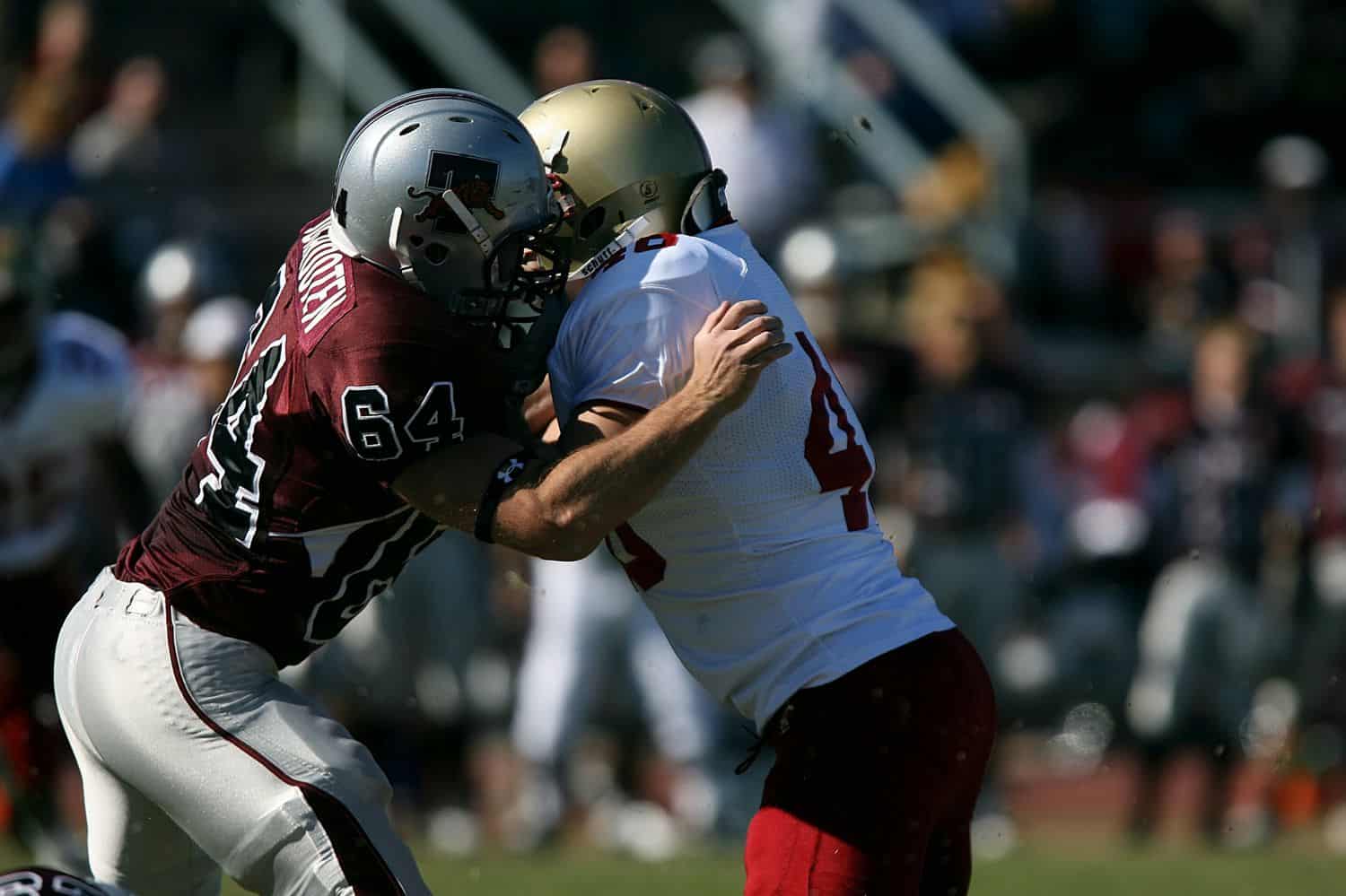 Two football players from opposing teams