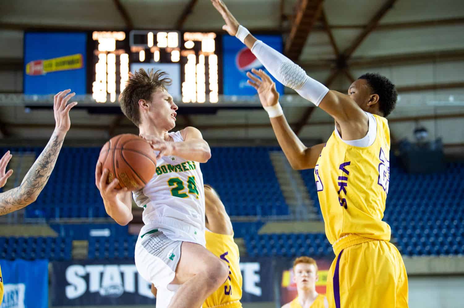 High school basketball players face off on the boys court