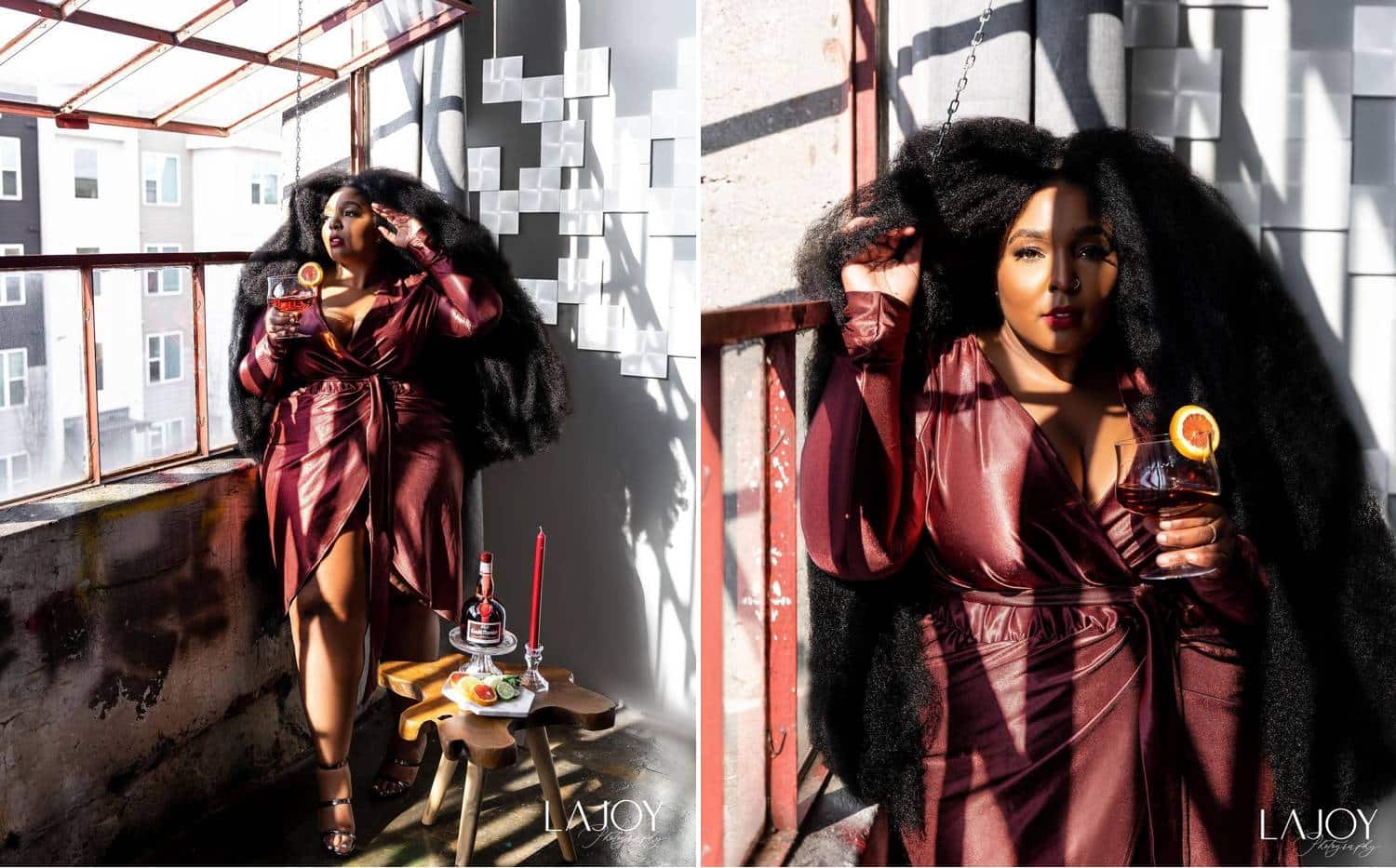 Photos: LaJoy Cox's portraits of a Lizzo look-alike show the gorgeous woman leaning against a concrete wall as harsh sun illuminates her striking face, burgundy leather dress, and the cocktail she's holding.