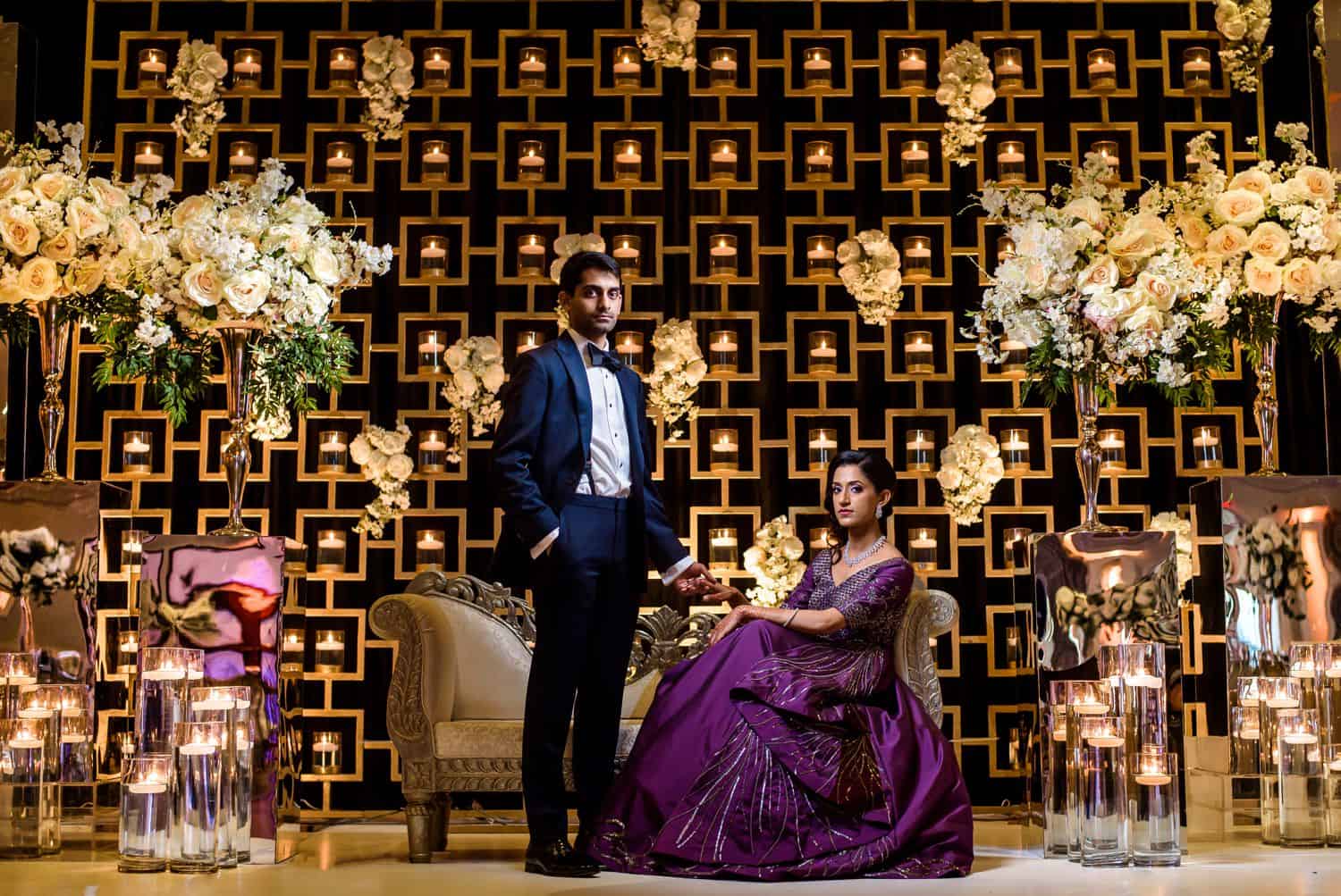 Make Money with Photography: Indian bride and groom pose with groom standing and bride seated