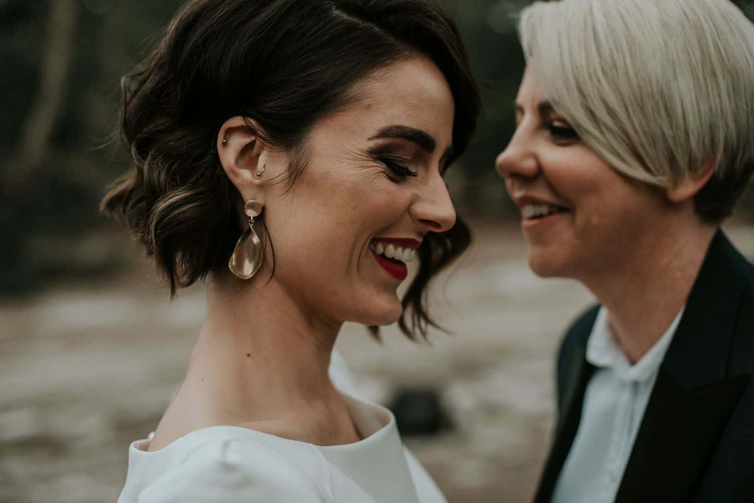 Close-up wedding portrait of laughing couple.