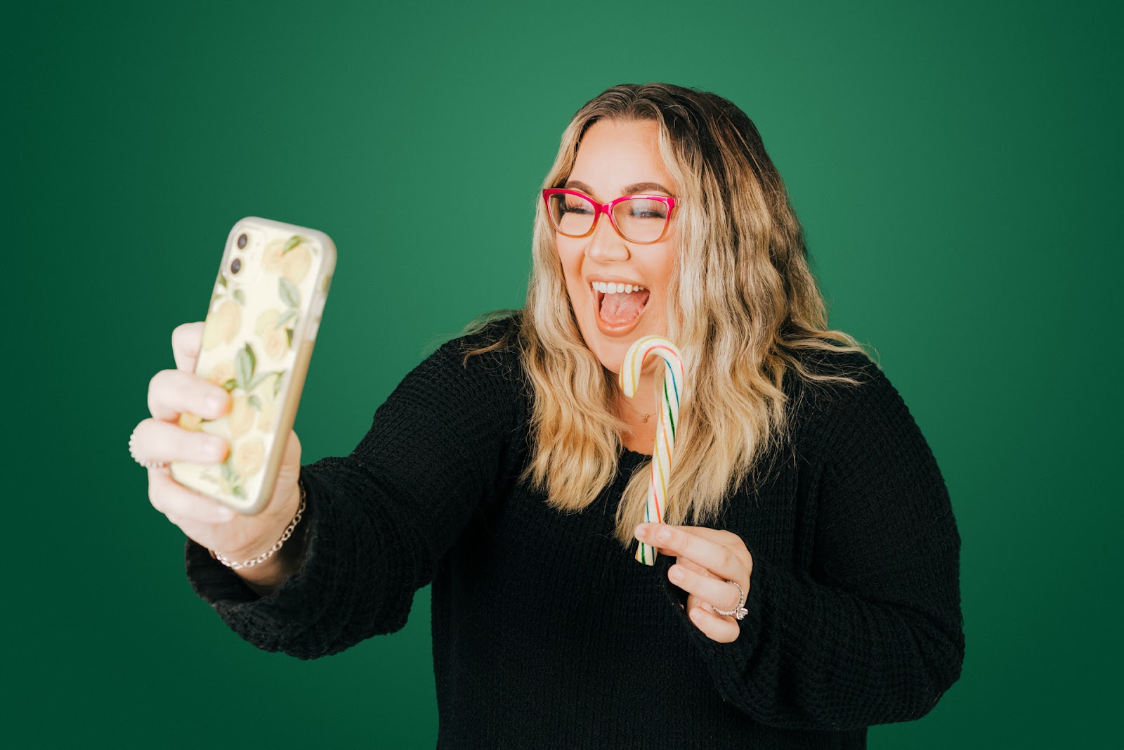 Girl taking selfie holding a candy cane