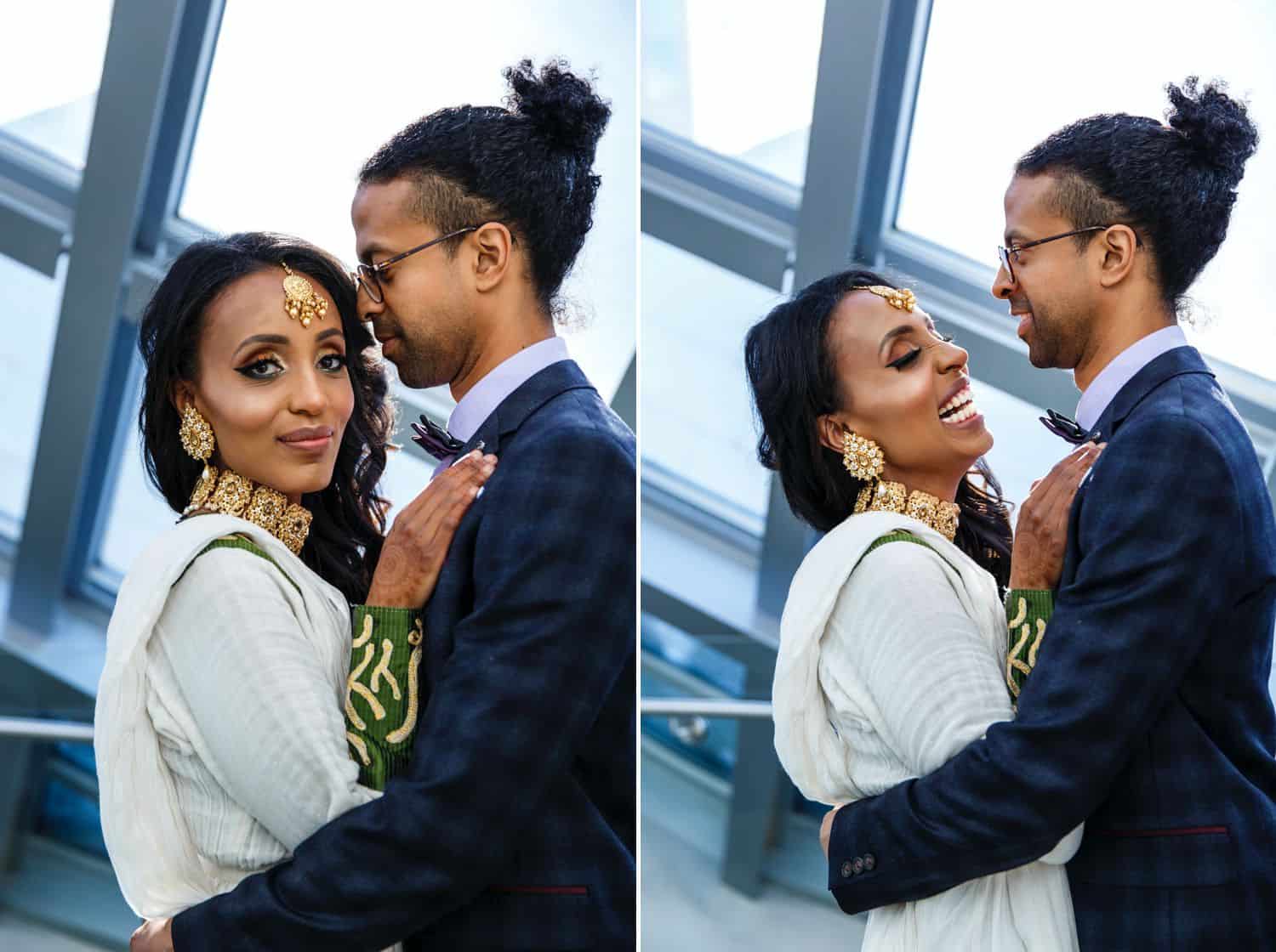 A bride and groom pose for portraits in a large atrium with an off-camera flash adding light to their faces