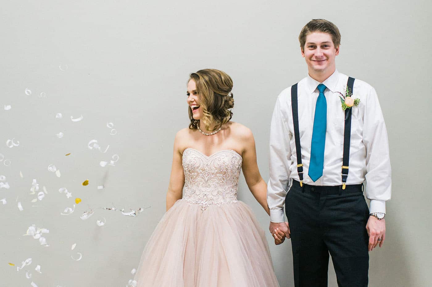 laughing bride and groom under confetti rachael osborn client questions