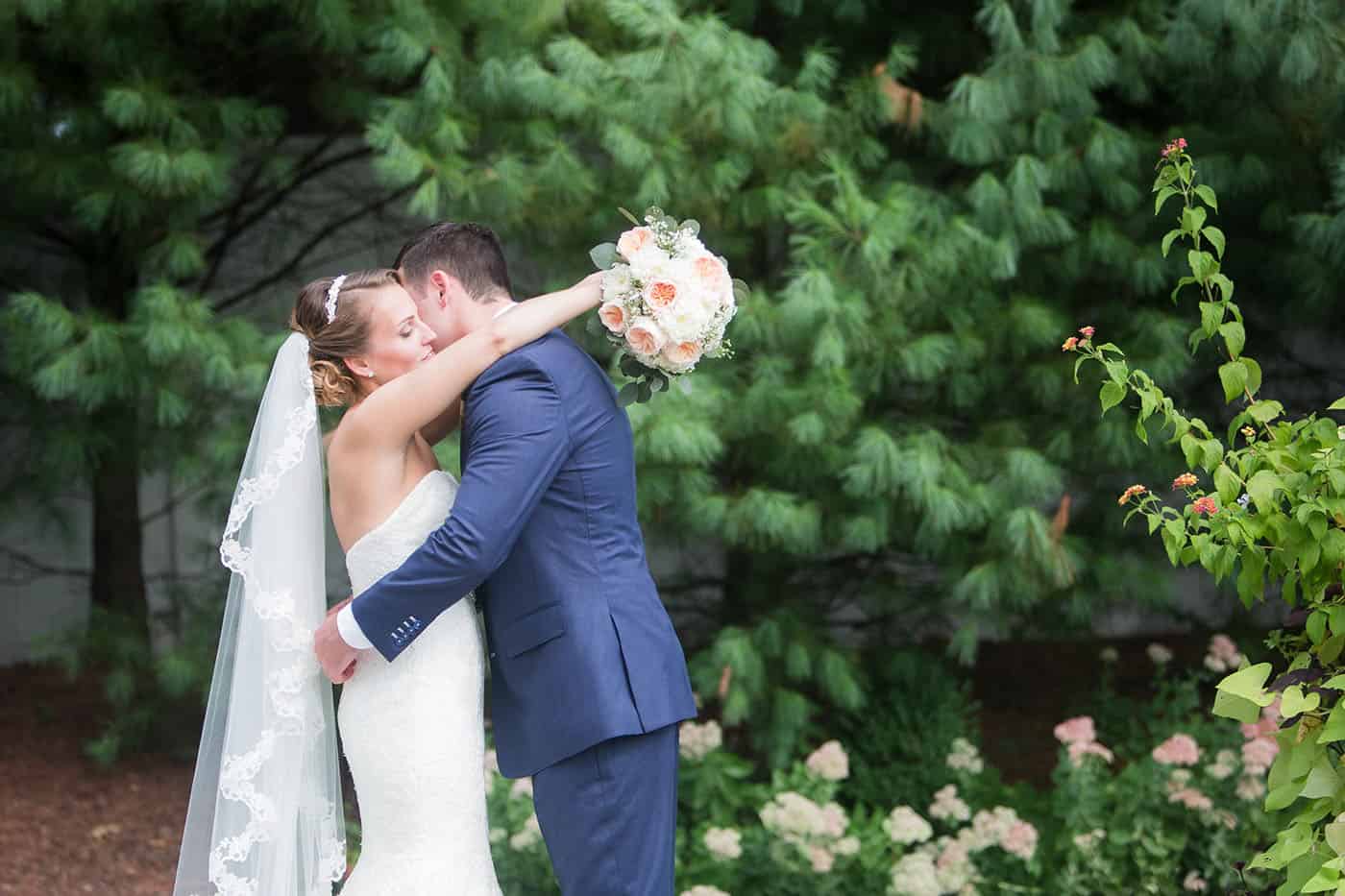 bride and groom hugging with bouquet by customer service whiz cinnamon wolfe