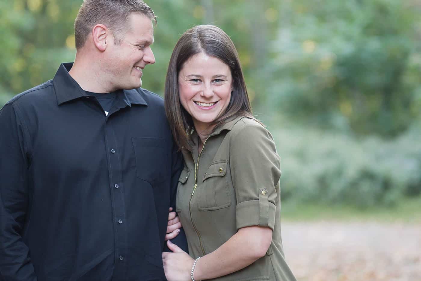 outdoor engagement portrait in navy and olive by customer service whiz cinnamon wolfe