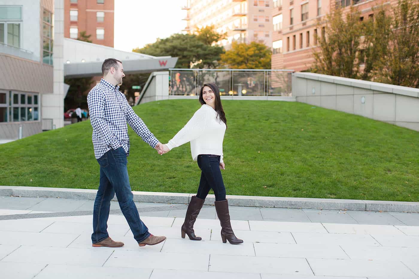 happy engaged couple walking through the city by customer service whiz cinnamon wolfe
