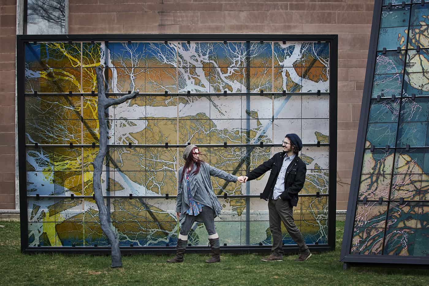 Urban Photo Locations - young hipster couple walking past an enormous wall mural