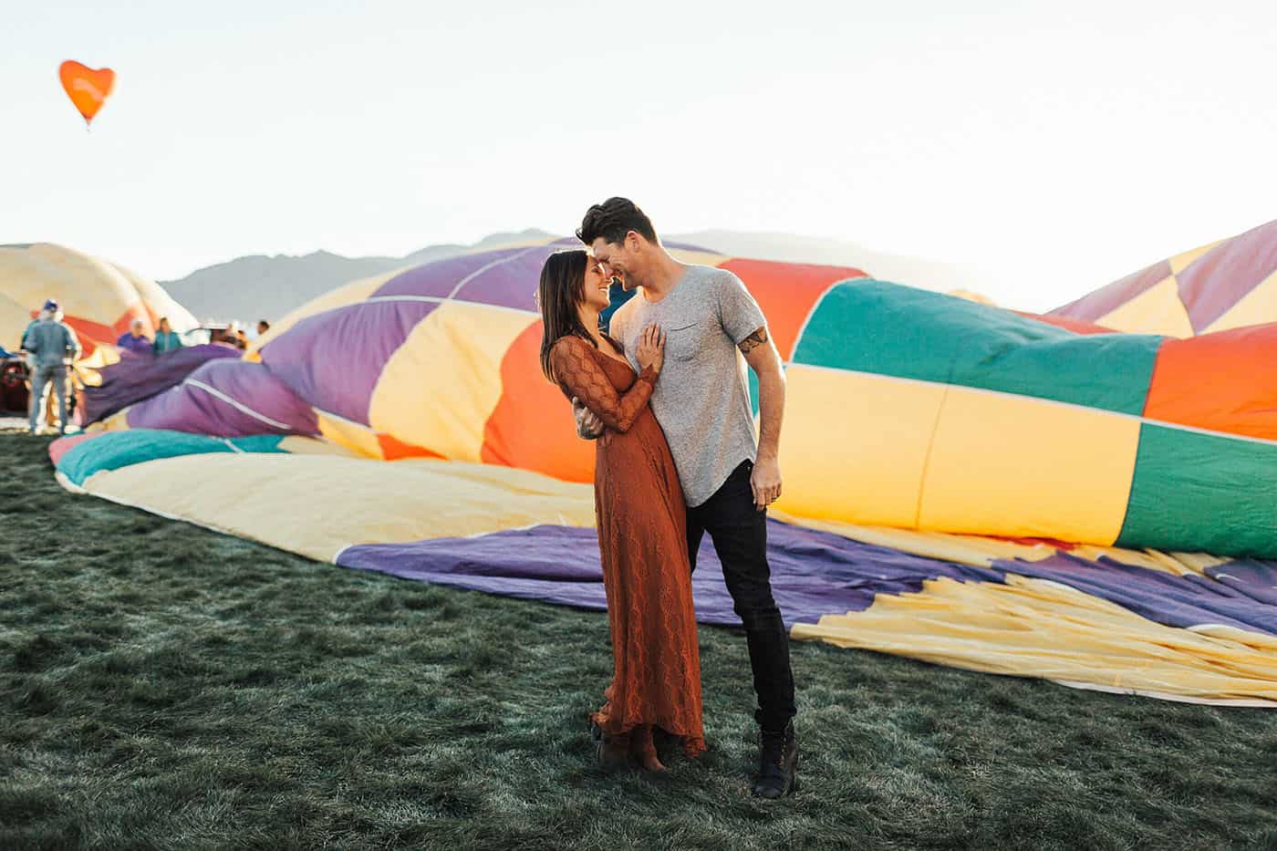 Memorable Photo Locations - brunette couple gazing into one another's eyes at a hot air balloon festival