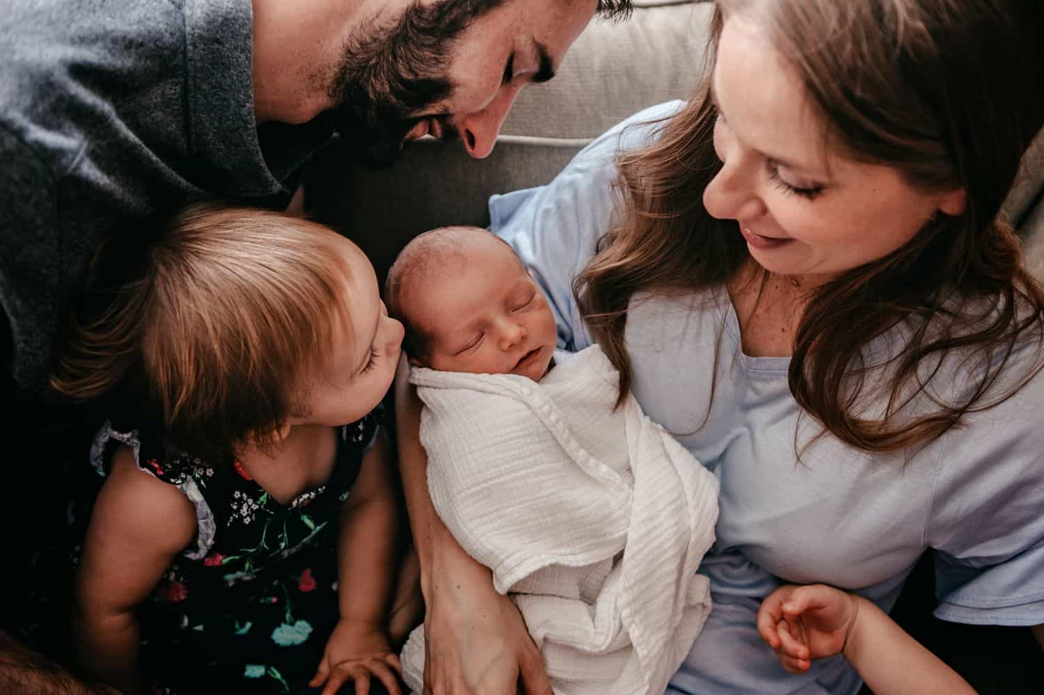 The Ultimate Portfolio Review Tool: A family gathers around their newborn baby.