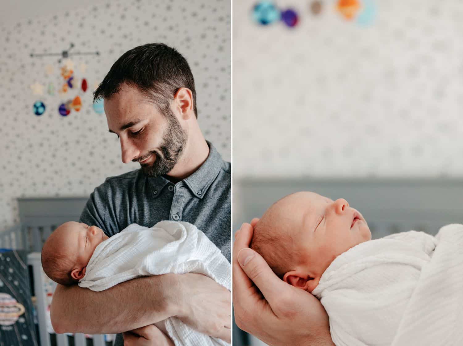 Dad holds his newborn son in the nursery.