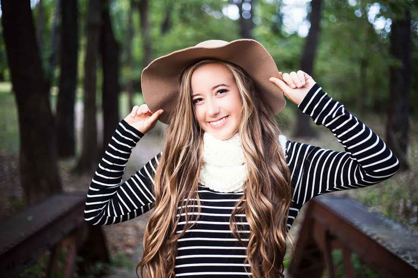 beautiful blonde smiling teenage girl in a floppy hat by Heather Yeager