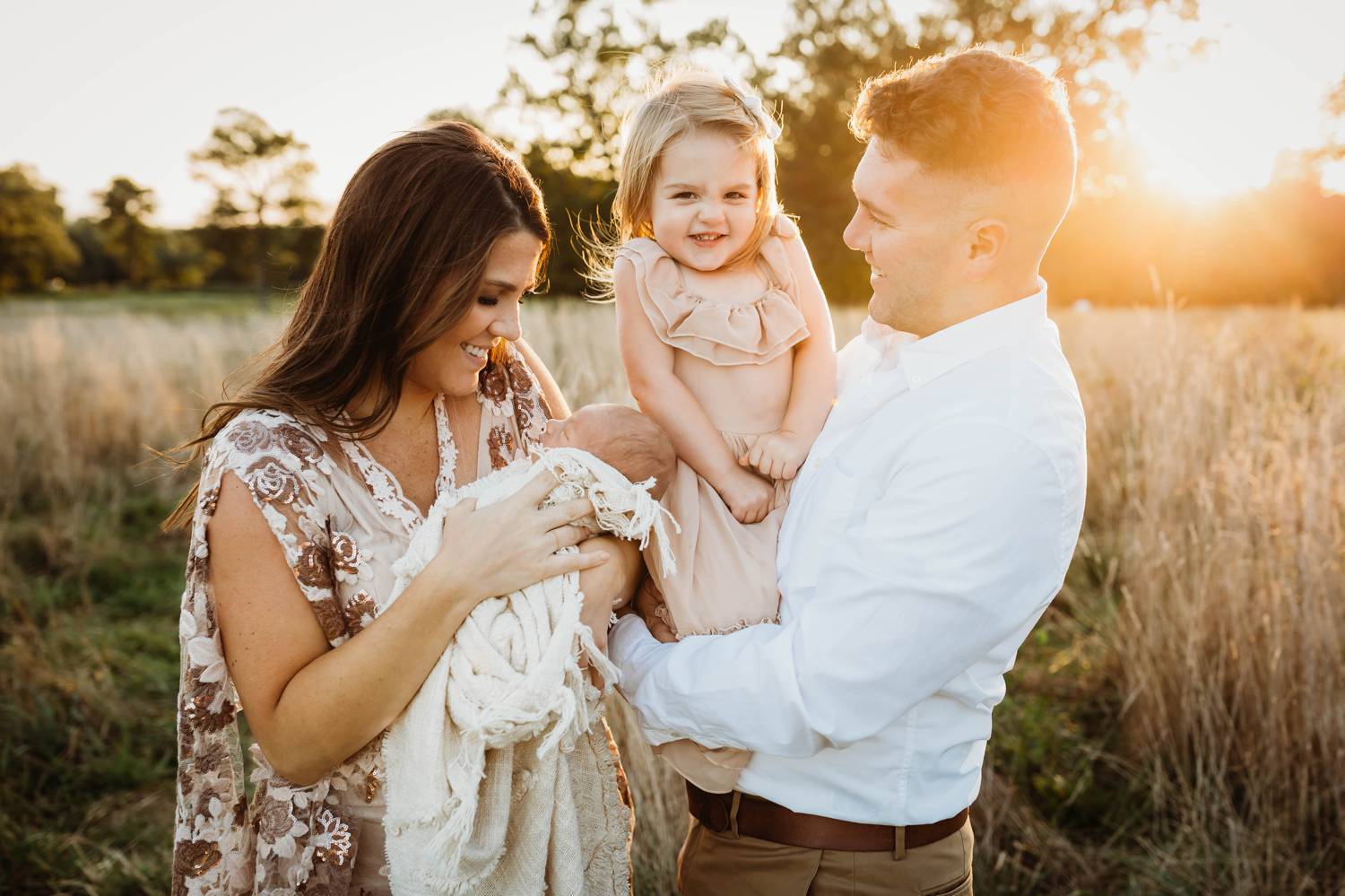 Family portrait in a field at dusk