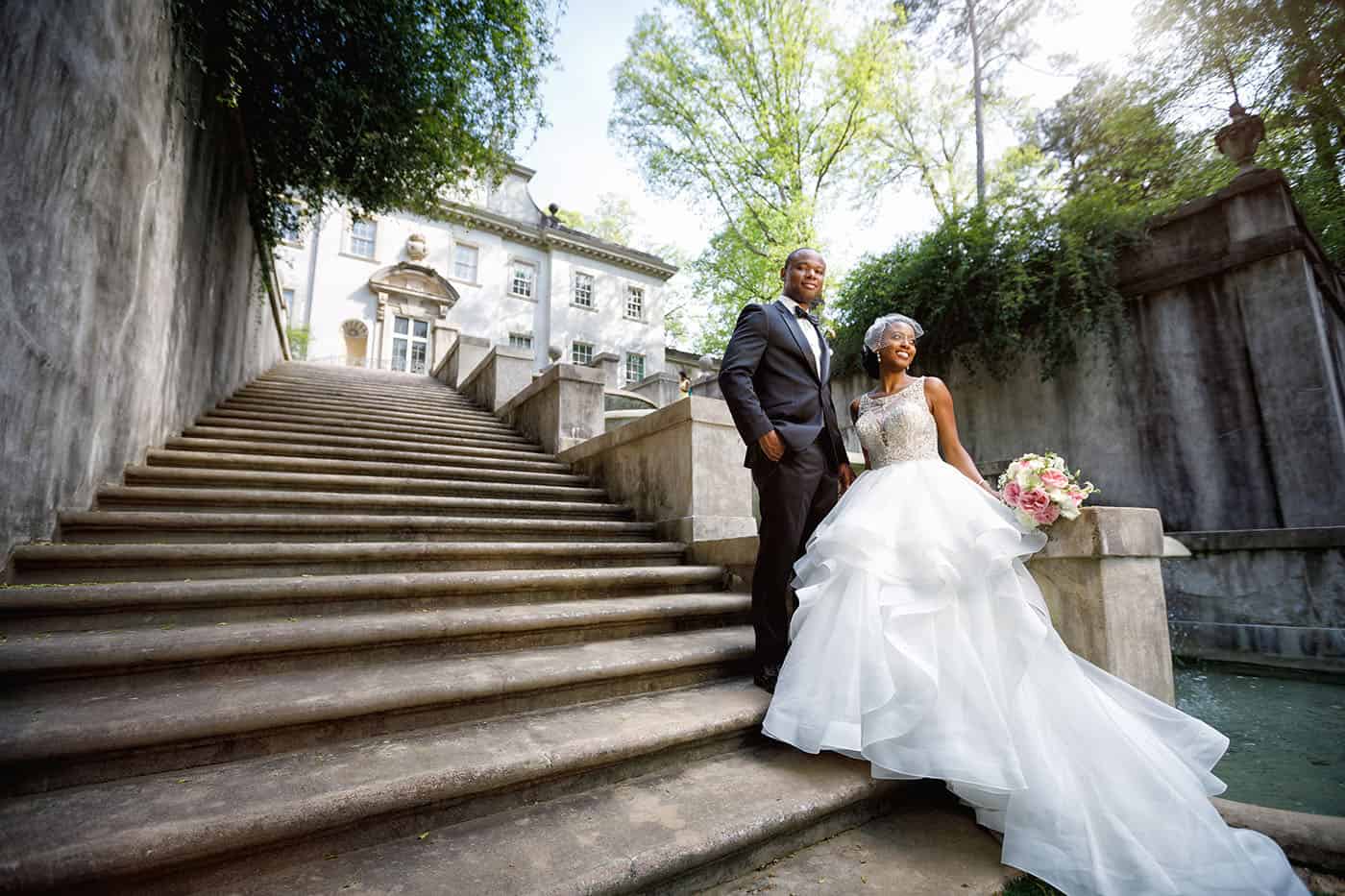 This is the Key to Amazing Client Relationships | A bride and groom pose on the broad stone staircase that leads up to the Atlanta History Center's Swan Mansion.