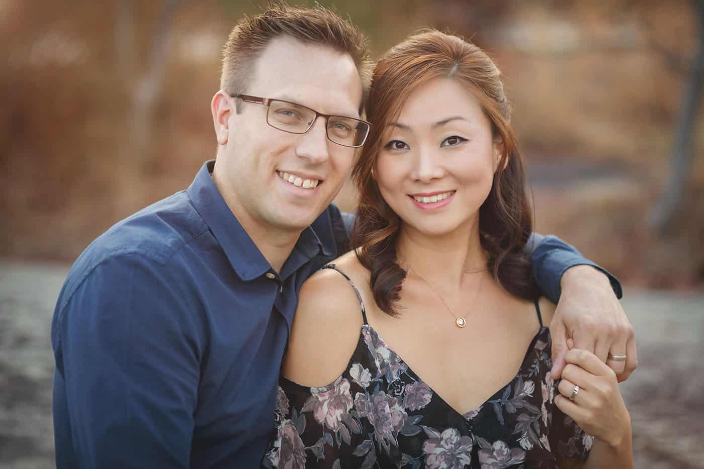 Photographer Craig Obrist is photographed outside with his wife Unchong, who co-runs his photography business.