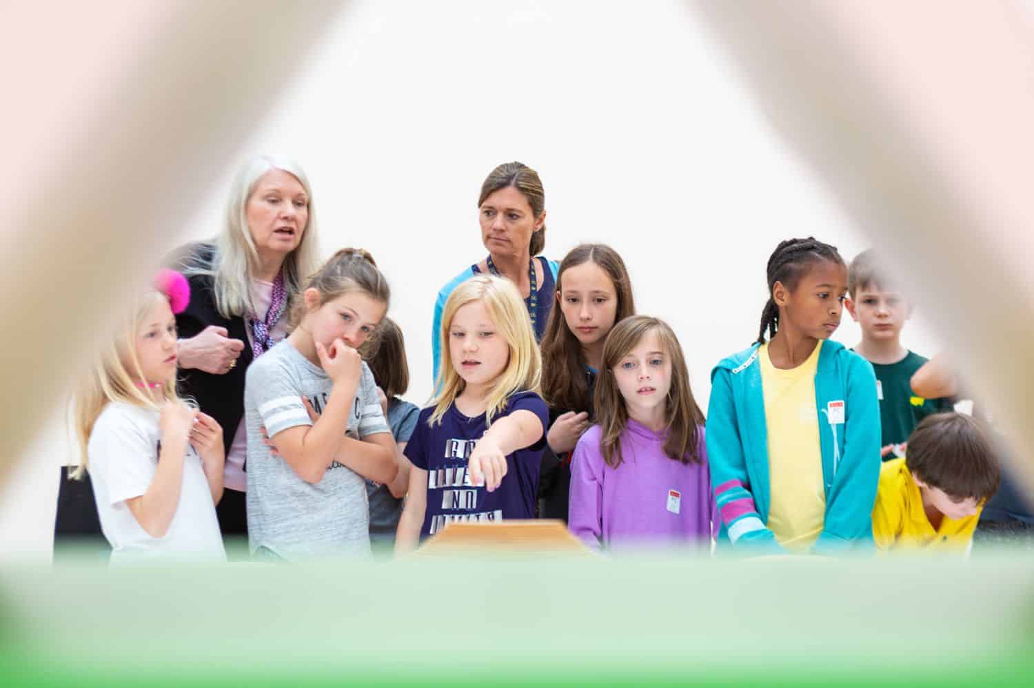 Build Your Dream Photography Business on a Budget: Children and teachers point at an unknown science experiment at an educational event