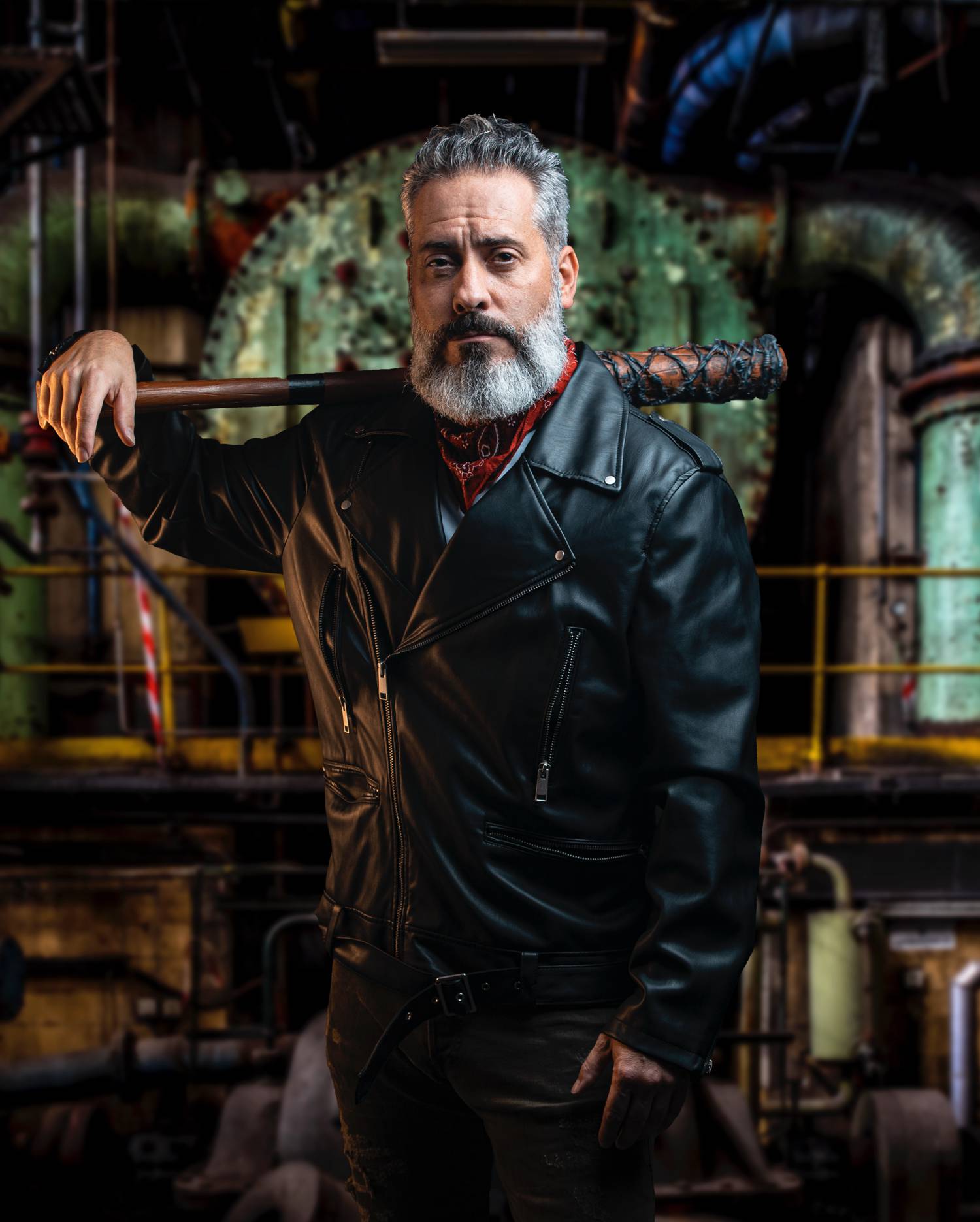 In this styled tribute photograph by Alexander Worth of Jawfox Photography, a man cosplays Negan from The Walking Dead, wearing a leather jacket and carrying the villain's barbed wire-wrapped bat, Lucille.