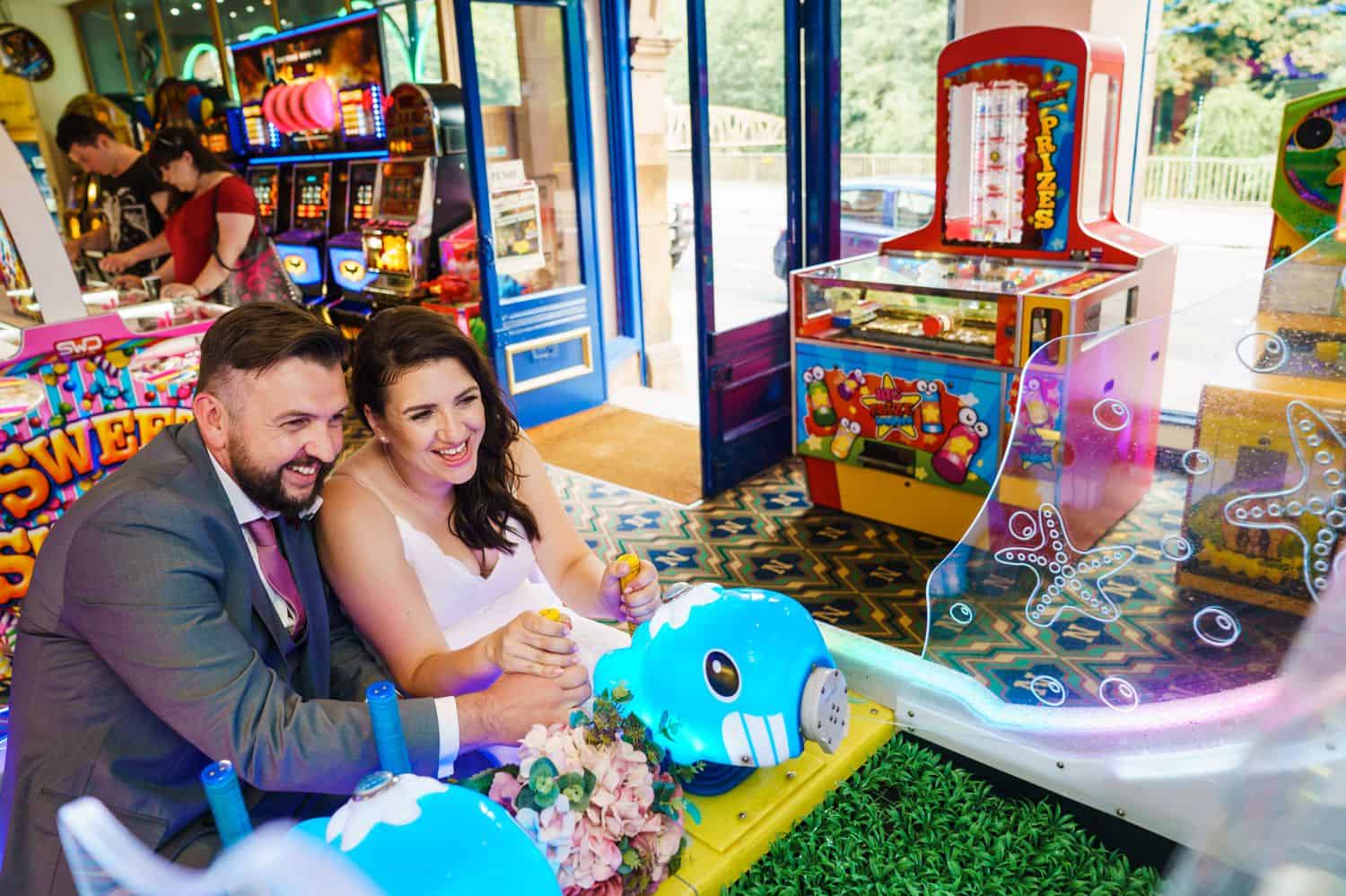 A bride and groom play carnival games on their wedding day